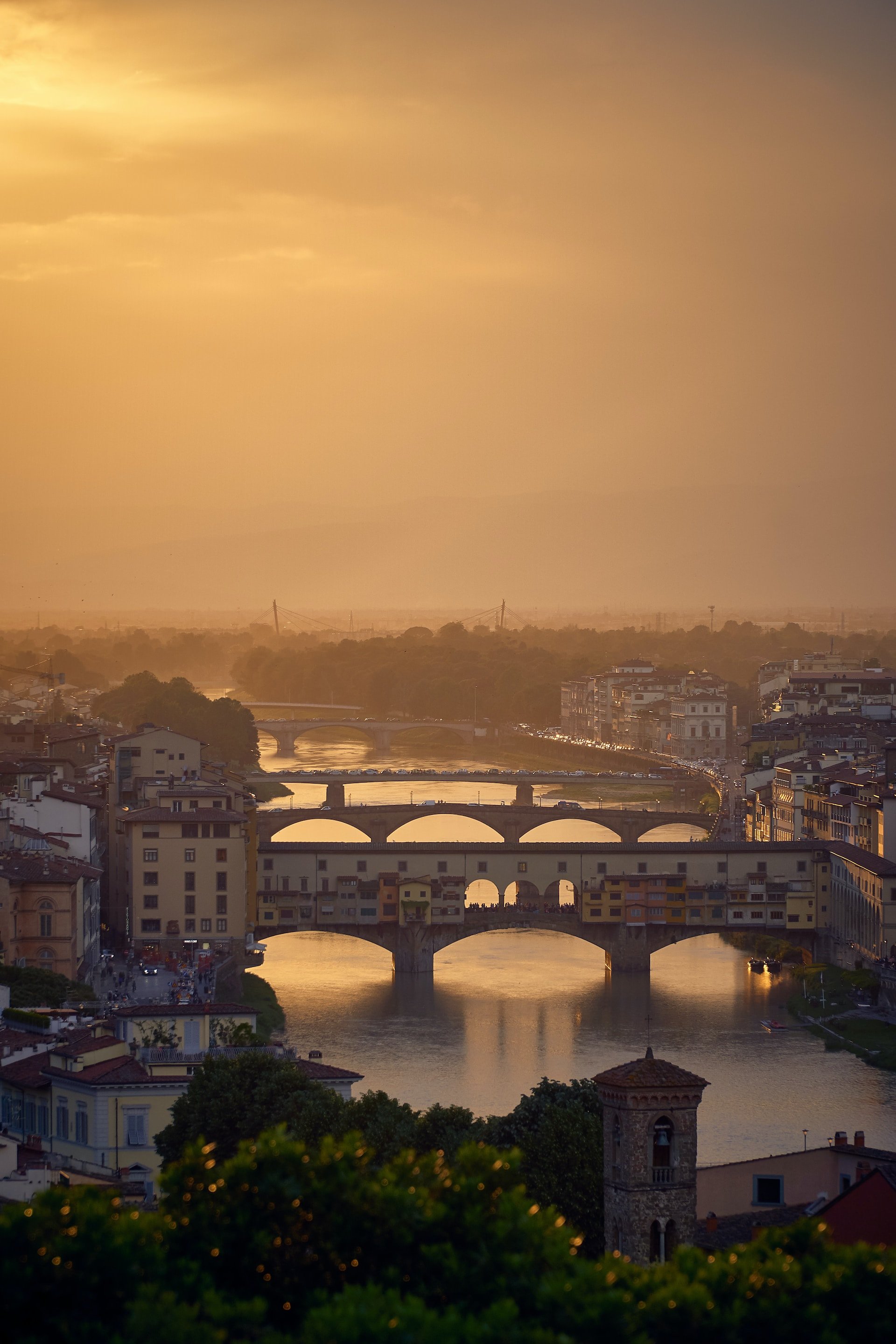 Stroll Across the Ponte Vecchio (Florence). One of Florence’s most iconic landmarks, this medieval bridge is lined with charming jewelry boutiques and offers romantic views over the Arno — especially at sunset.